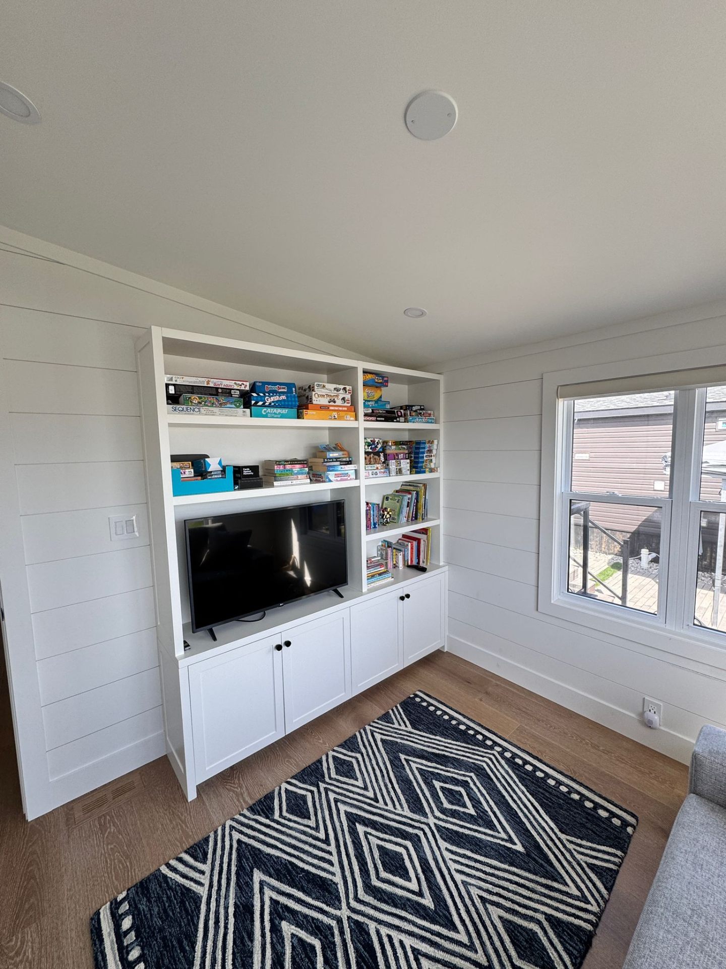 Custom built-in shelving and media cabinet in the den
