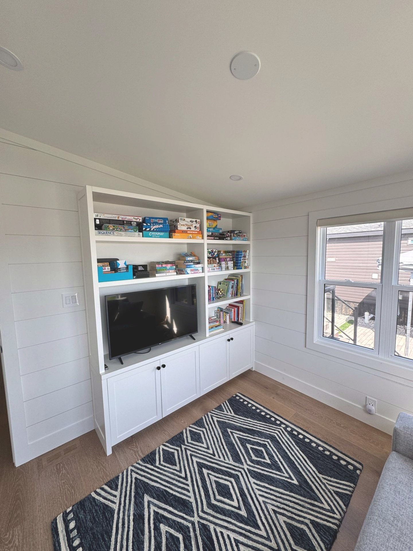 Custom built-in shelving and media cabinet in the den