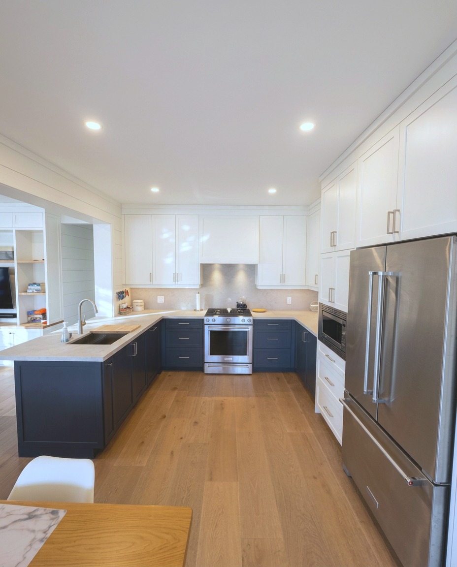 Custom chef's kitchen with navy cabinetry, quartz counters and stainless appliances